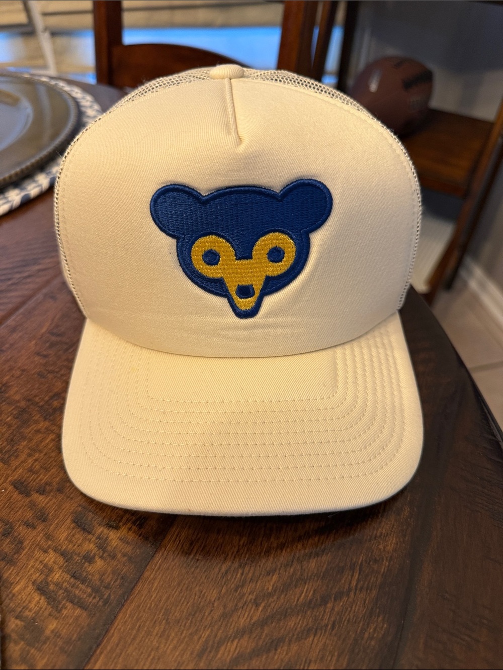 Mitchell & Ness Cream Trucker Hat with Blue and Yellow Bear Logo.